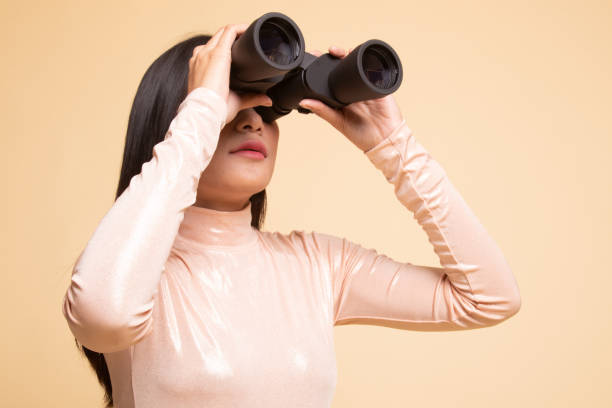 istock Young Asian woman with binoculars. 1146311116