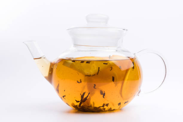 istock Glass teapot with green tea isolated on white background 1146311197