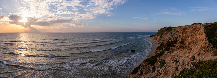 Beautiful Panoramic View on the Ocean Coast duing a vibrant sunset at the Apollonia Beach. Taken in Herzliya, Tel Aviv District, Israel.