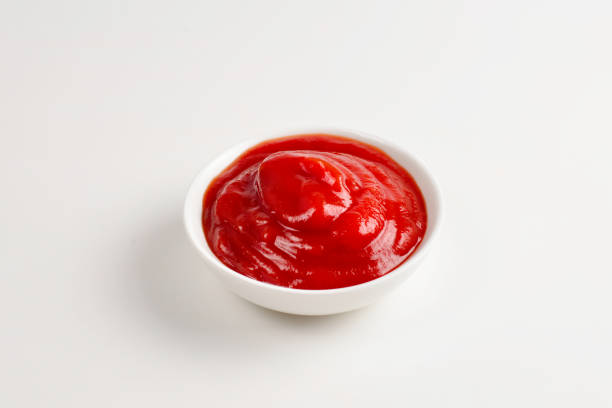 istock Ketchup in white plate on white background. 1146311541