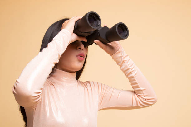 istock Young Asian woman with binoculars. 1146312187
