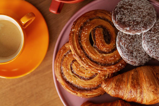 istock Top view of sweet rolls and coffee on table set for breakfast 1146312215