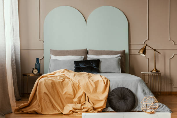 istock Pastel blue headboard of king size bed with cozy bedding and pillows 1146314422