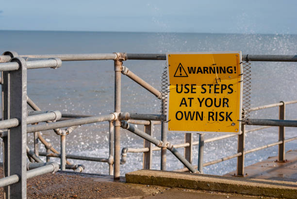 istock A danger sign at a british coastline with waves crashing in the background. 1146317455