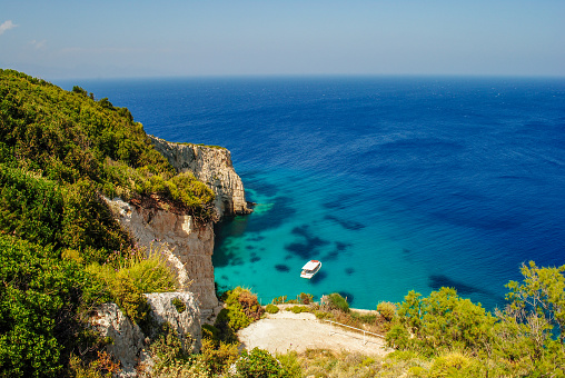A idyllic coast line, with blue clear waters and tall cliff edges