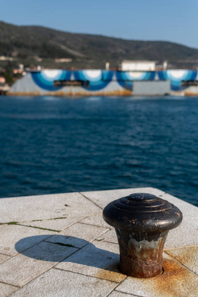 Harbor bollard for large naval vessels. The port wharf in central europe. Season of the summer.