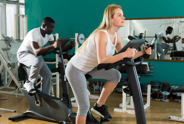 istock Couple training on stationary cycles 1146318270