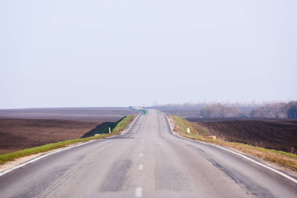 istock Serene countryside lanscape. Empty asphalt road in empty fields and clear sky in sunny day copyspace. Traveling concept 1146320040