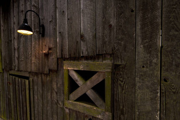 The letter 'F' painted on weathered red-painted wood siding