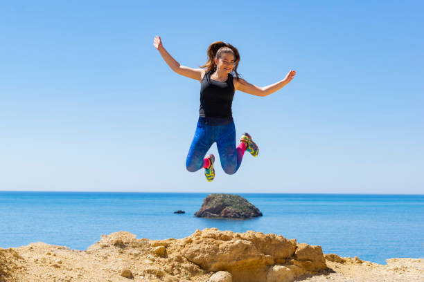 istock Very happy woman jumping 1146325484
