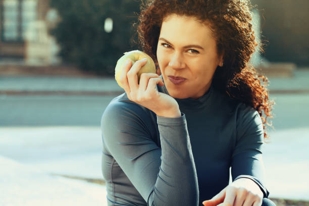 istock Young woman eating an apple 1146328384