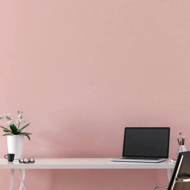Workdesk with decoration in front of empty pink wall with copy space. 3D rendered image.
