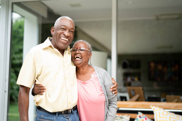 Portrait of a senior couple embracing at home Portrait of a senior couple embracing at home pictures of husband and wife pictures stock pictures, royalty-free photos & images