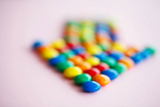 istock Pointer on the Pink Background. Colored Candy. Diet. Healthful N 1146334021