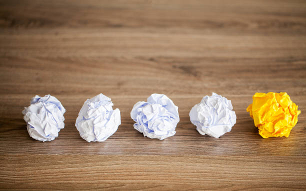 istock Great idea concept. Crumpled colorful paper on wooden table 1146344014