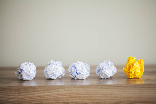 istock Great idea concept. Crumpled colorful paper on wooden table. Copy space 1146344103