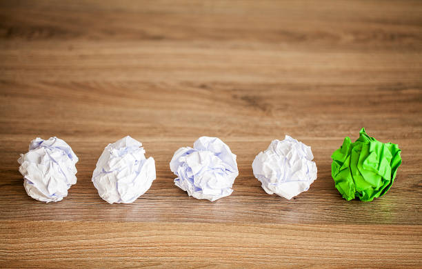 istock Great idea concept. Crumpled colorful paper on wooden table. Copy space 1146344124