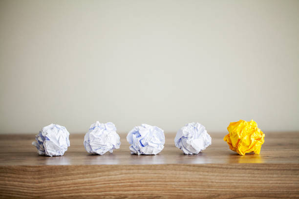 istock Great idea concept. Crumpled colorful paper on wooden table. Copy space 1146344859