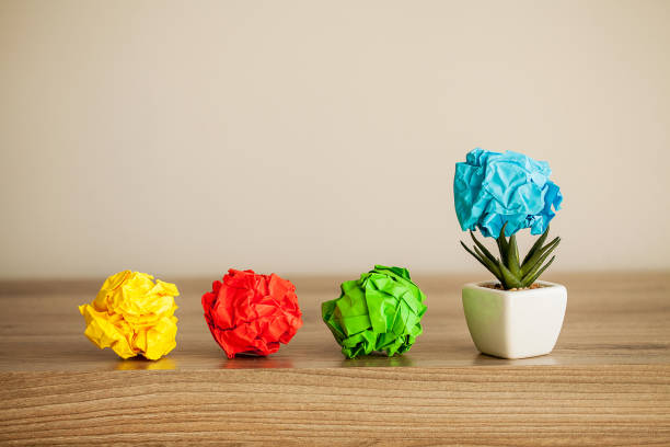 istock Great idea concept. Crumpled colorful paper on wooden table. Copy space 1146344874