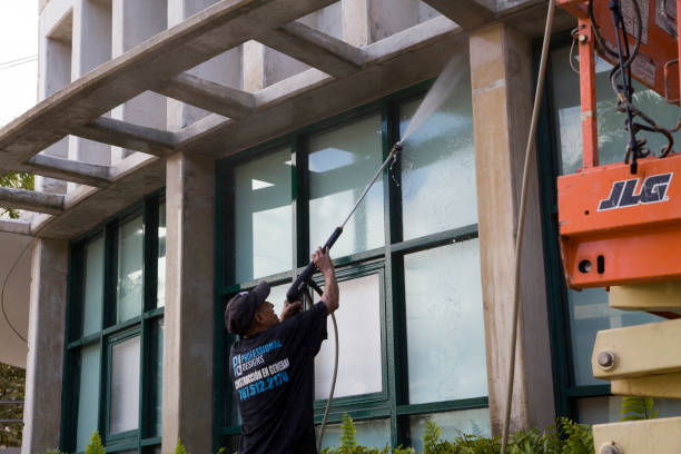 Hispanic man using high pressure washer to clean glass Bayamon Puerto Rico stock photo