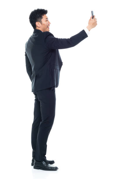 istock Attractive looking Chinese businessman - taking a selfie 1146349892