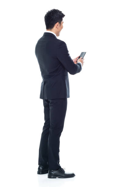 istock Attractive looking Chinese businessman - texting on smart phone 1146349934