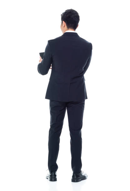 istock Attractive looking Chinese businessman - texting on smart phone 1146349939