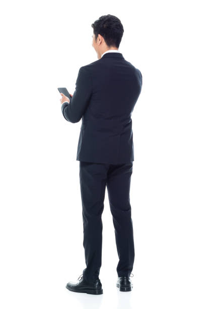 istock Attractive looking Chinese businessman - texting on smart phone 1146349944