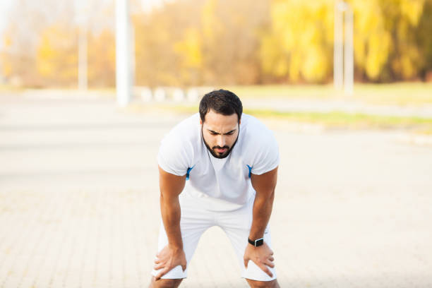 istock Fitness. Exhausted runner man resting on the park after workout 1146350806