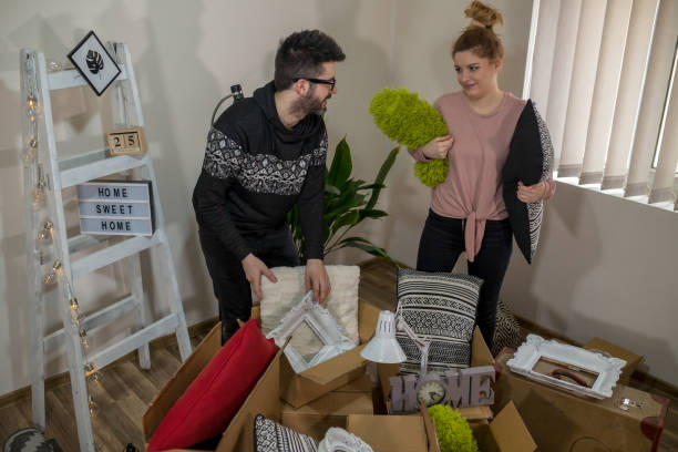 istock Couple packing stuff among plenty of cardboard boxes 1146350981
