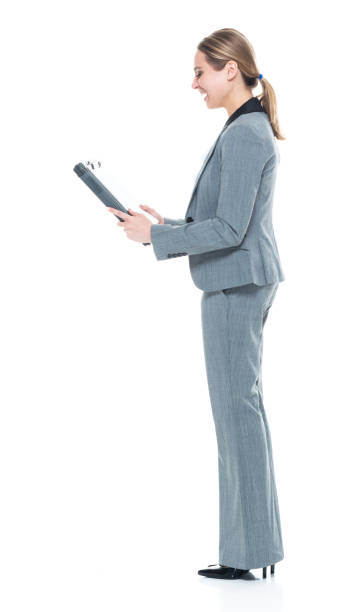 istock Businesswoman in grey suit on white background - using a clipboard 1146351076