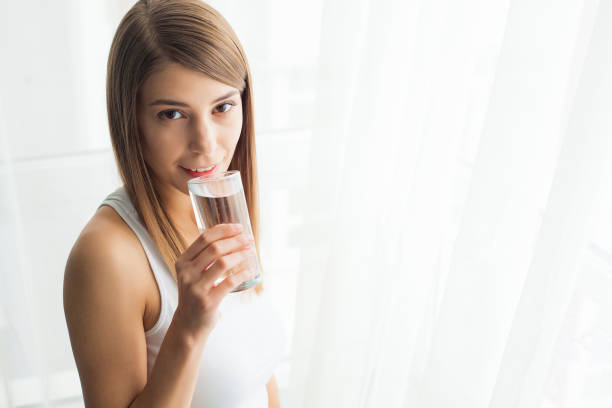 istock Young woman drinking water. Drinking fresh water 1146352011