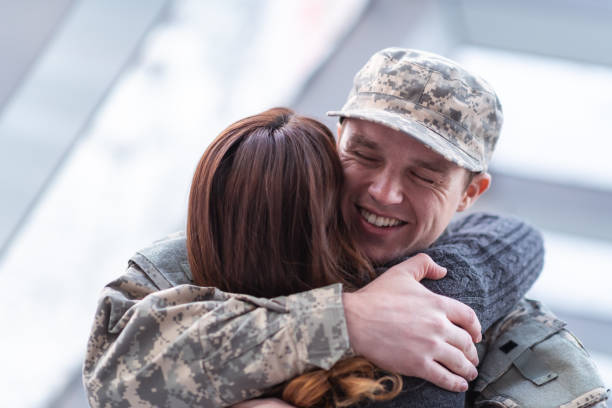 istock Woman hugging her partner after returning home from service 1146354030