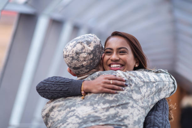 istock Woman hugging her partner after returning home from service 1146354031