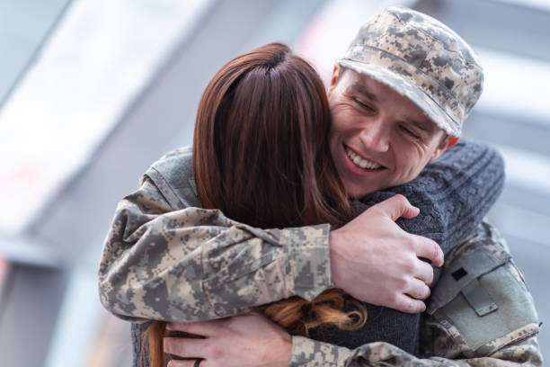 istock Woman hugging her partner after returning home from service 1146354032