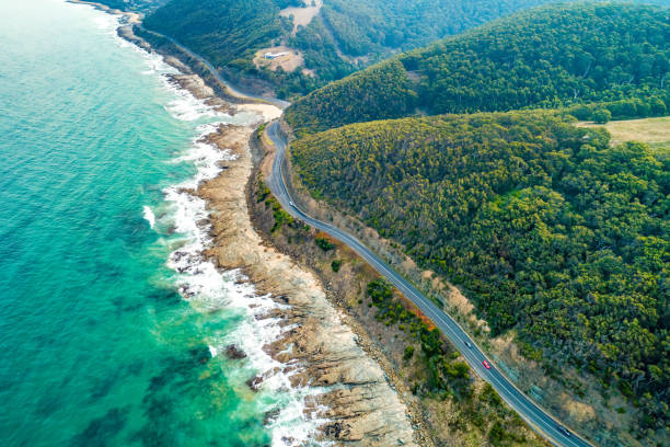 Cars driving on Great Ocean Road, Victoria, Australia  - aerial view stock photo