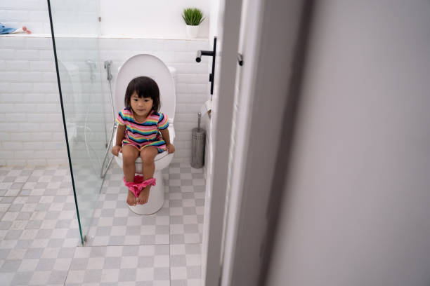 istock child sitting and learning how to use the toilet 1146361018