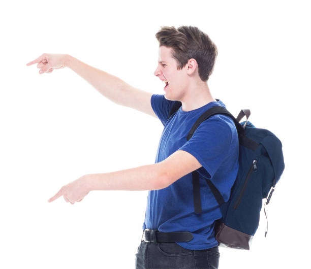 istock Young high school age male student is showing to the side 1146365732