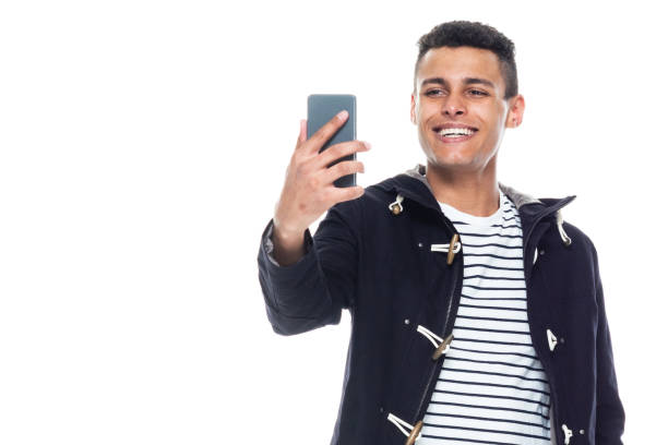 istock Handsome African American male standing on white background - taking a selfie 1146366054