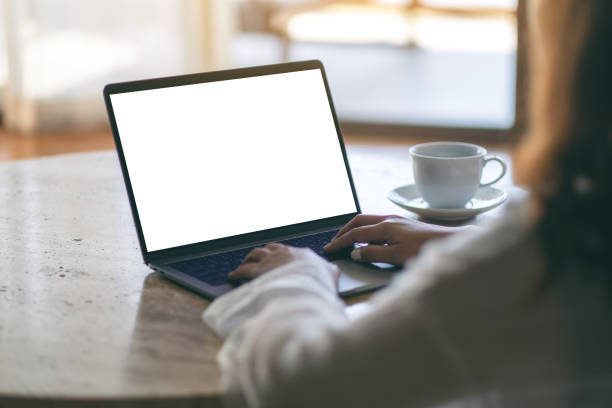 istock a woman using and typing on laptop with blank white desktop screen on the table 1146371422