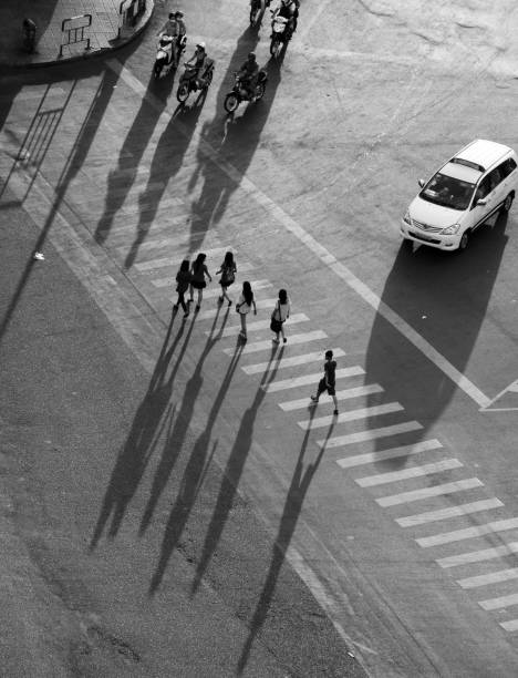 istock High view six people crossing on crosswalks with long shadow 1146372980