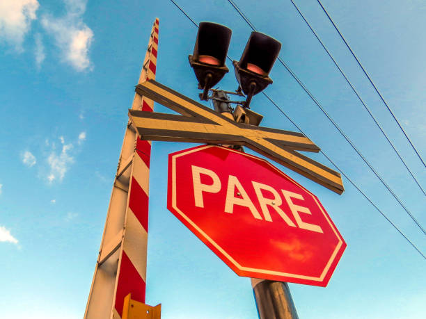Railroad stop warning sign spanish stock photo