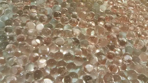 Closeup view with selective focus of shiny glittering orbeez or colorful water balls hydrogel. Water beads orbeez background.