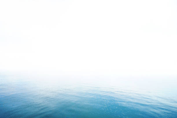 The blur cool sea background on horizon tropical sandy beach; relaxing outdoors vacation with heavenly mind view at a resort deck touching sunshine, sky surf summer clouds and light blue wave ocean.