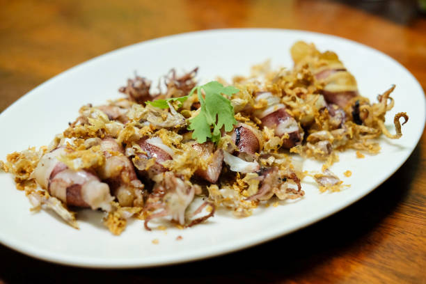 istock Squid Fried garlic and Seafood sauce in white disk 1146397121