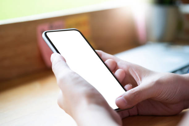 istock Mockup image of woman's hands holding mobile phone with blank screen in modern cafe 1146398297