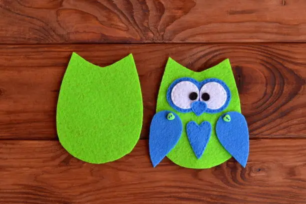 Photo of Soft felt toy pattern. Children sewing tutorial. Needlecraft sewing felt pattern. Felt body of a fabric owl. Stitched details toy