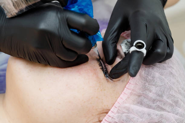 istock Permanent makup on face, woman having eyelid tattoo 1146399258