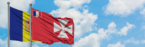 Andorra and Wallis And Futuna flag waving in the wind against white cloudy blue sky together. Diplomacy concept, international relations. Andorra and Wallis And Futuna flag waving in the wind against white cloudy blue sky together. Diplomacy concept, international relations. wallis and futuna islands stock pictures, royalty-free photos & images