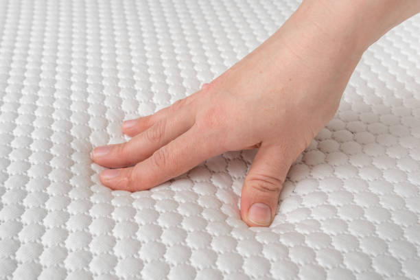 istock Woman is choosing new mattress for good sleeping 1146406818